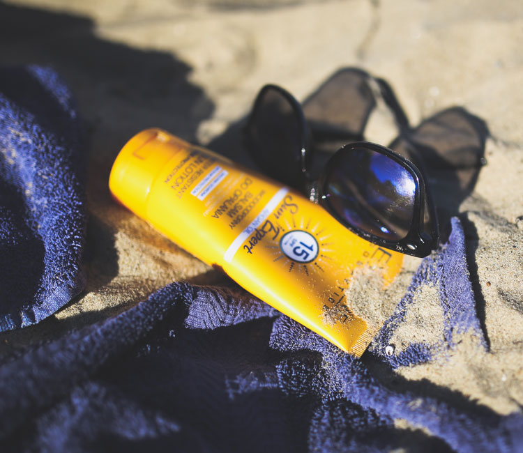 Sunblock and Sunglasses on Beach